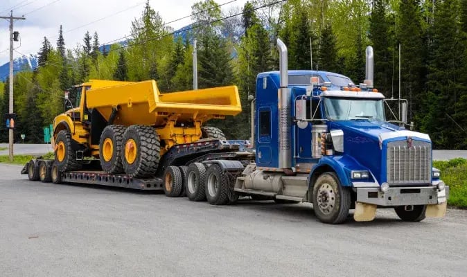 Over-the-Road Truck Hauling Articulated Dump Truck