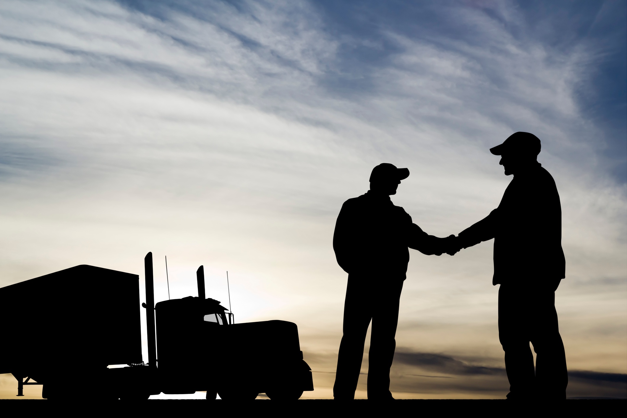 Trucker silhouette shaking hands-1